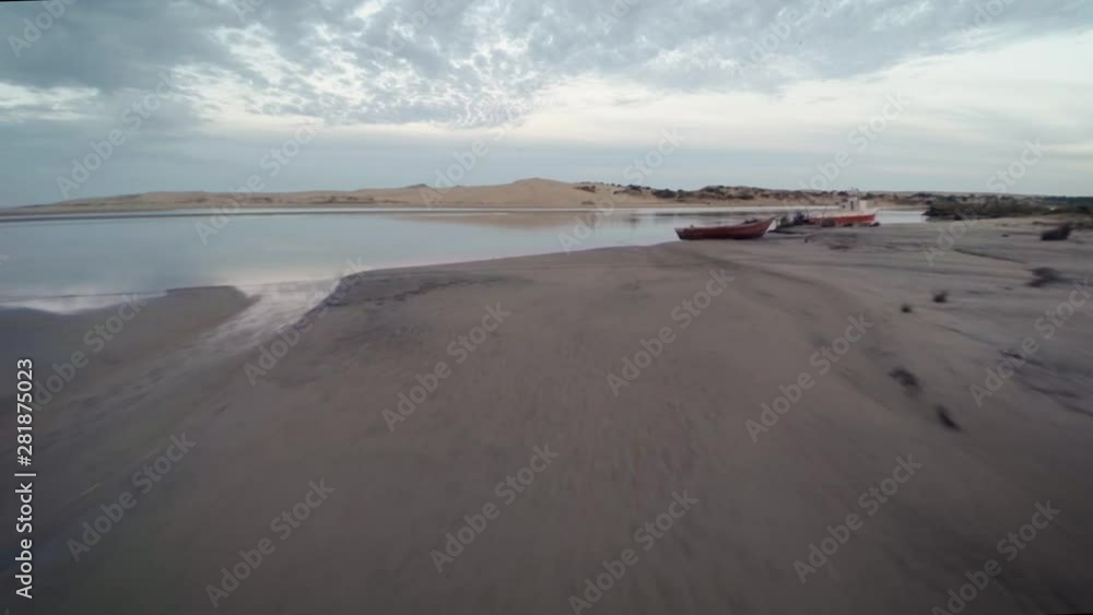 Breathtaking drone shot flyover of exotic beach location with flying birds Breathtaking drone shot flyover of exotic beach location with flying birds