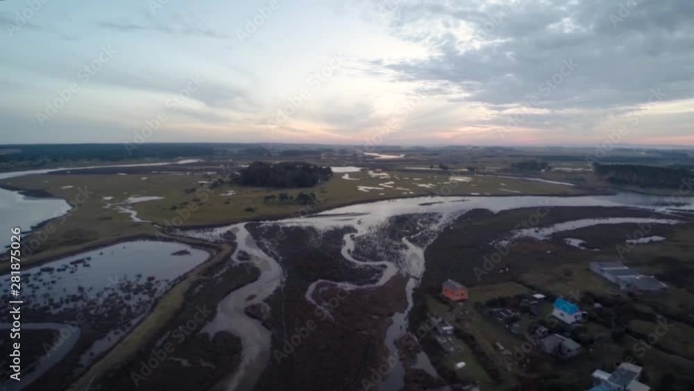 Multiple Rivers Converging Multiple rivers converge in a delta near a seaside bay town in the ...