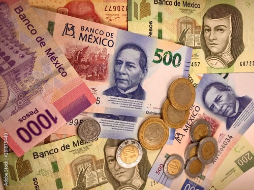 Mexican peso bills spread randomly over a flat surface