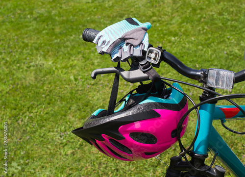 Bicycle helmet and gloves on handlebar.