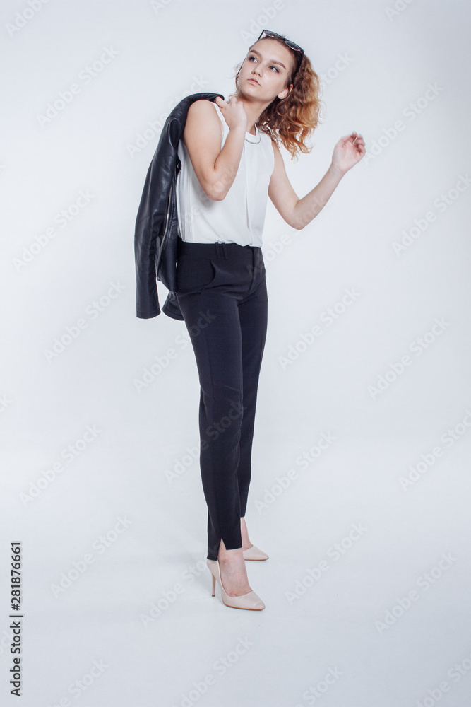 Pretty young fashion sensual woman posing on white background with dressed in hipster style leather jacket outfit. Stylish fashionable girl hipster in black clothes and white shirt. Pretty young fashion sensual woman posing on white background with dressed in hipster style leather jacket outfit. Stylish fashionable girl hipster in black clothes and white shirt.