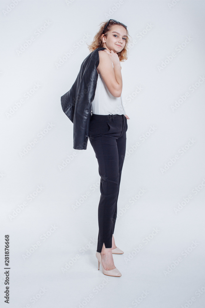 Pretty young fashion sensual woman posing on white background with dressed in hipster style leather jacket outfit. Stylish fashionable girl hipster in black clothes and white shirt. Pretty young fashion sensual woman posing on white background with dressed in hipster style leather jacket outfit. Stylish fashionable girl hipster in black clothes and white shirt.