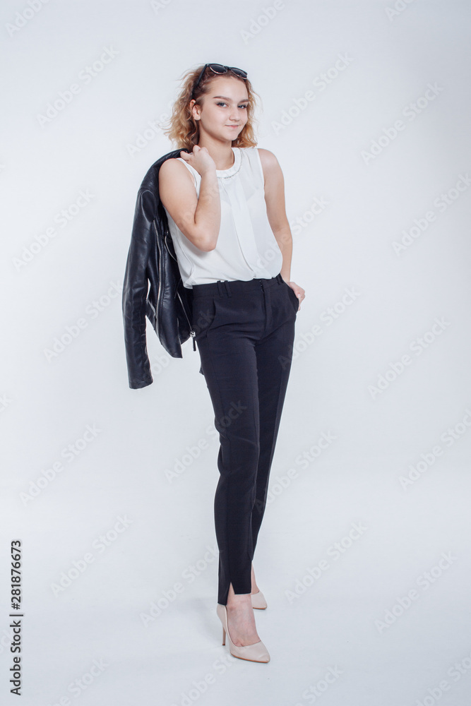 Pretty young fashion sensual woman posing on white background with dressed in hipster style leather jacket outfit. Stylish fashionable girl hipster in black clothes and white shirt. Pretty young fashion sensual woman posing on white background with dressed in hipster style leather jacket outfit. Stylish fashionable girl hipster in black clothes and white shirt.