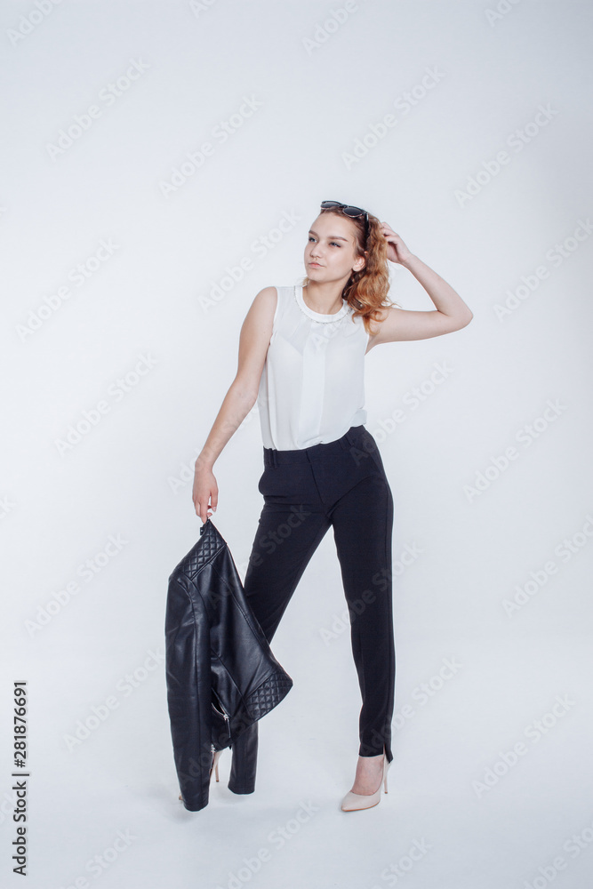 Pretty young fashion sensual woman posing on white background with dressed in hipster style leather jacket outfit. Stylish fashionable girl hipster in black clothes and white shirt. Pretty young fashion sensual woman posing on white background with dressed in hipster style leather jacket outfit. Stylish fashionable girl hipster in black clothes and white shirt.