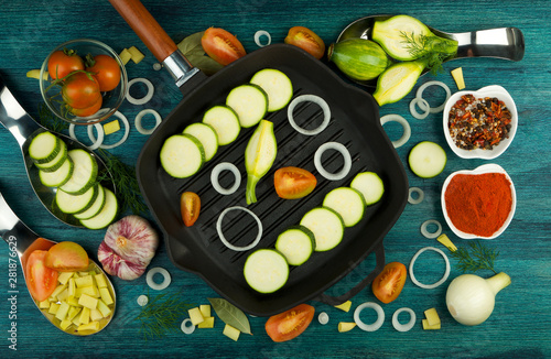 VEGETABLES ON BACKGROUND. FRESH VEGETABLES AND SPICES NEAR A FISHING SET ON A WOODEN SURFACE. COPY SPACE