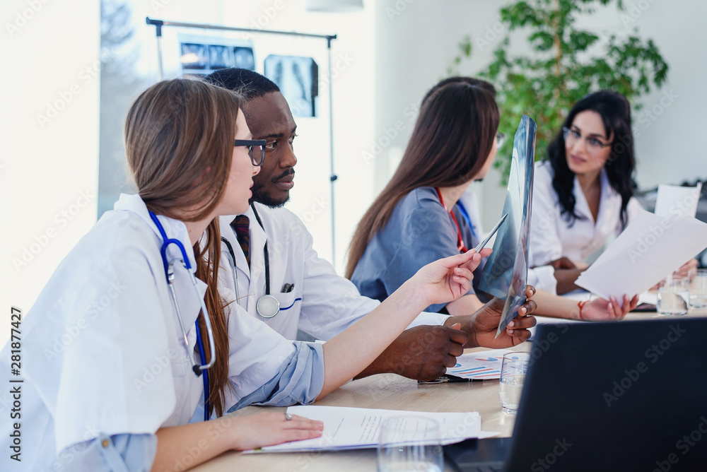 Team of professional doctors having a meeting in conference room at the modern hospital. Health care and medical developmant concept. Team of professional doctors having a meeting in conference room at the modern hospital. Health care and medical developmant concept.