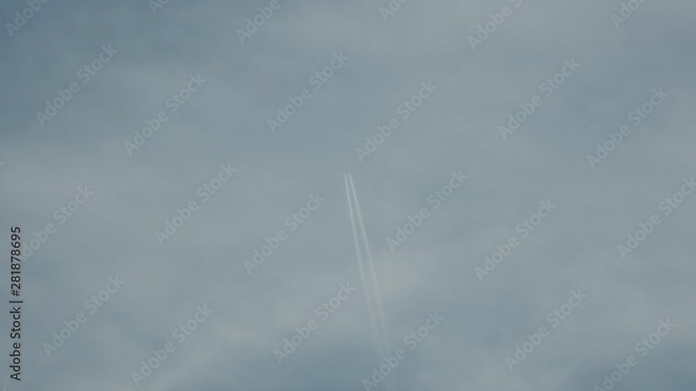 Airplane at cruising altitude against blue sky and light clouds. Airplane at cruising altitude against blue sky and light clouds.