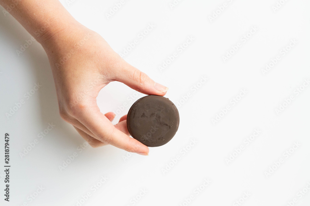 Girl holding thin mints cookies, chocolate mint thin round cookies Girl holding thin mints cookies, chocolate mint thin round cookies