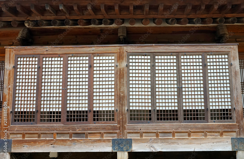 Part of the facade with a closed window of an ancient Korean palace building. Deoksugung Palace, Seoul. Part of the facade with a closed window of an ancient Korean palace building. Deoksugung Palace, Seoul.