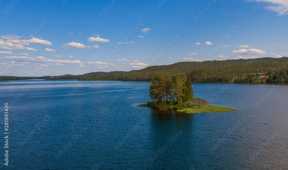 Small island on the Storån-Österdalälven lake in Idre, Sweden. Drone shot, july 2019