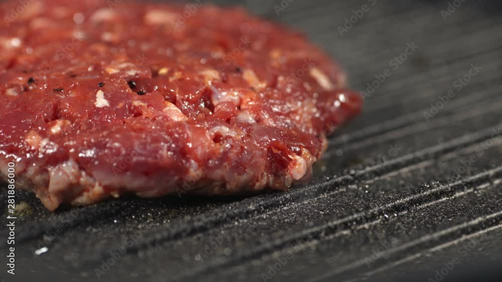 Raw red minced cutlet is on the grill to make a delicious Burger barbecue Raw red minced cutlet is on the grill to make a delicious Burger barbecue