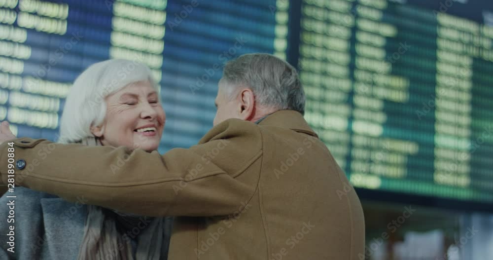 Close up of the senior Caucasian man and woman beeing happy and joyful while hugging and meeting at the airport. Close up of the senior Caucasian man and woman beeing happy and joyful while hugging and meeting at the airport.