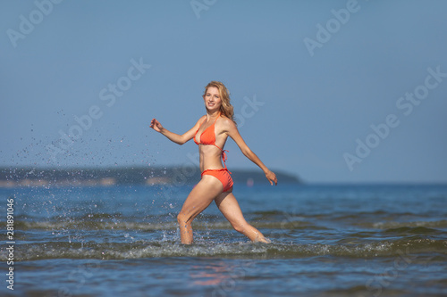young happy girl in bikini at sea