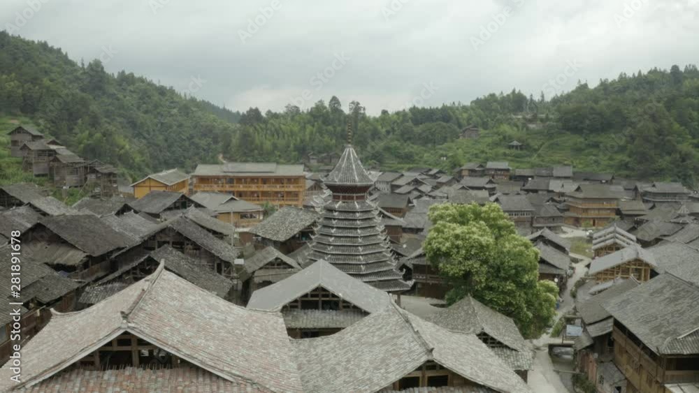 Dong minority village roof line aerial Guizhou, China. flying around ancient drum bell Tower pagoda. Dong minority village roof line aerial Guizhou, China. flying around ancient drum bell Tower pagoda.