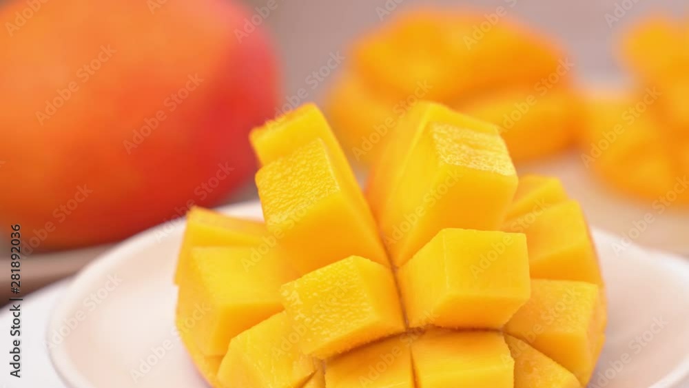 Beautiful fresh chopped mango, showing on a rotating white plate, close up, 4K video shot. Beautiful fresh chopped mango, showing on a rotating white plate, close up, 4K video shot.