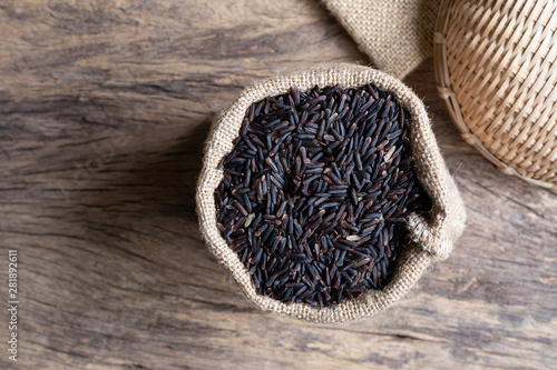 top view of gaba rice in a sack bag on wooden table.  nutrition source for healthy food concept.