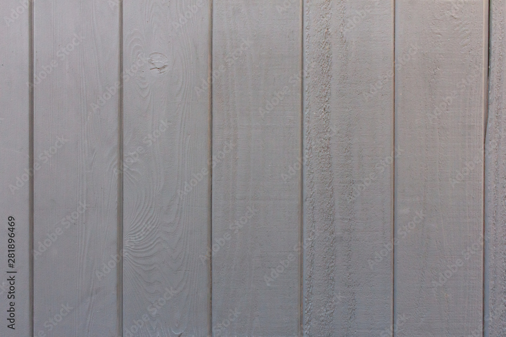 A neutral grey painted treated wood background A neutral grey painted treated wood background