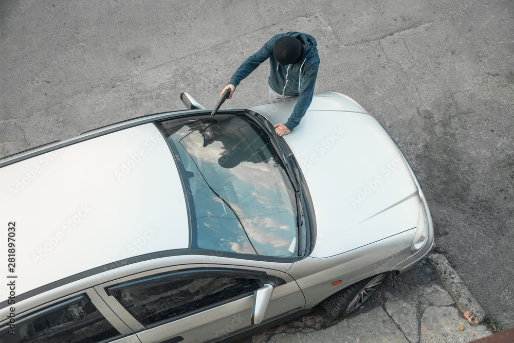 Car theft in black mask with a pistol. Car theft in black mask with a pistol.