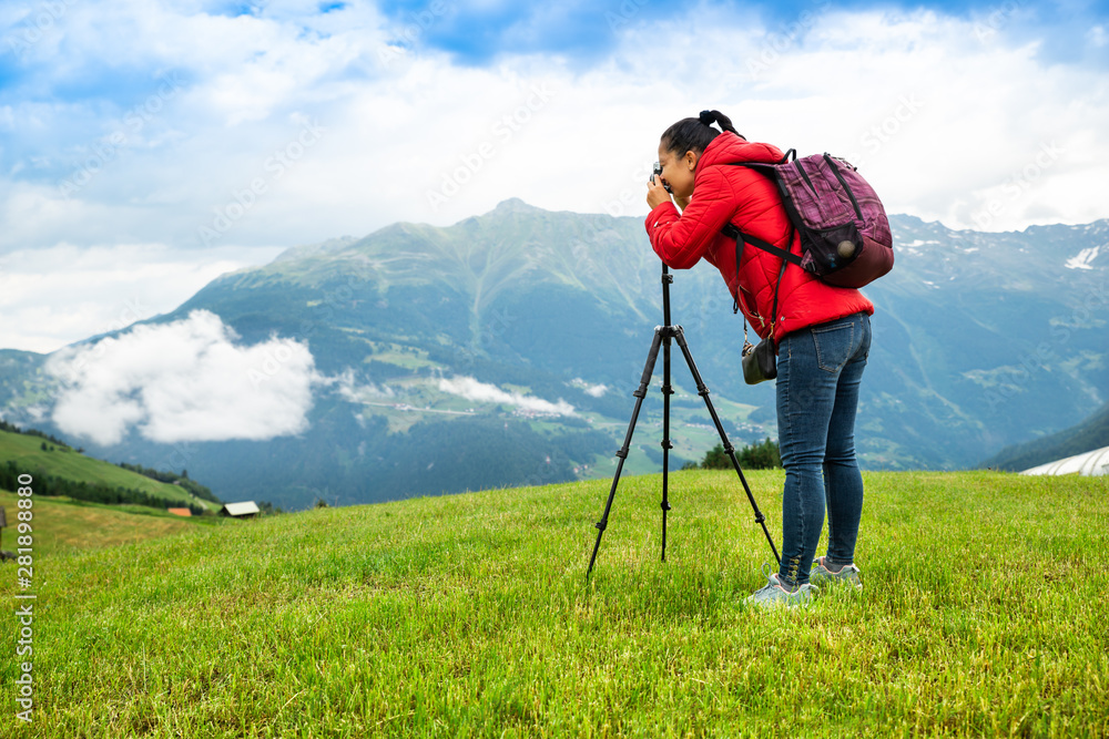 Woman Taking Photo Of Mountain Landscape