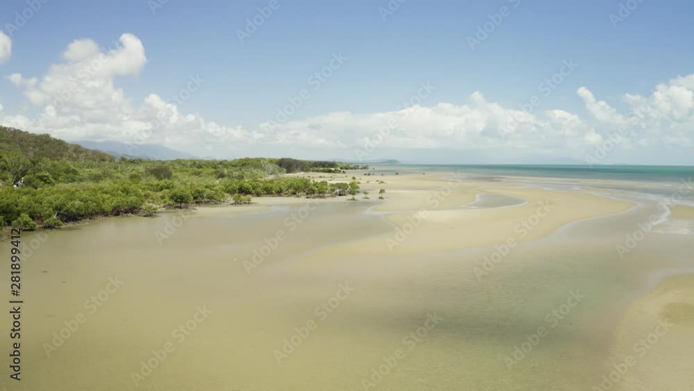 Aerial, low tide and huge sand ocean bed and mangroves growing in Queensland Australia Aerial, low tide and huge sand ocean bed and mangroves growing in Queensland Australia