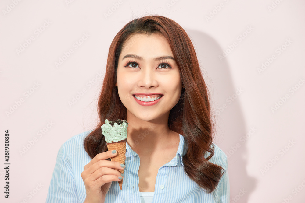 Sweet happy moments of attractive fashionable young woman having fun with cone ice cream on pink background. Dreaming, delicious, enjoying, happiness, smiling Sweet happy moments of attractive fashionable young woman having fun with cone ice cream on pink background. Dreaming, delicious, enjoying, happiness, smiling