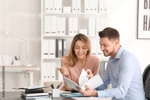 Businessman consulting young woman in office photo