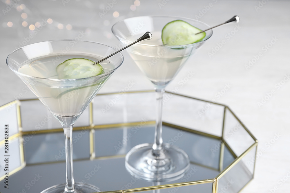 Tray with glasses of cucumber martini on grey table, space for text Tray with glasses of cucumber martini on grey table, space for text