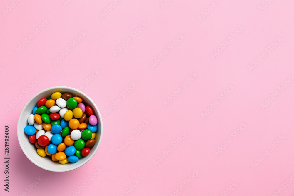 Delicious bright glazed candies on pink background, top view. Space for text