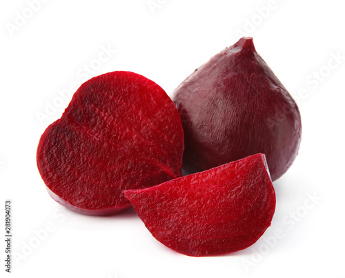 Whole and cut boiled red beets on white background