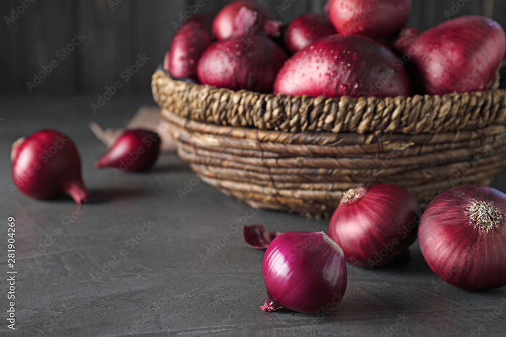 Fresh whole red onion bulbs on grey table. Space for text Fresh whole red onion bulbs on grey table. Space for text