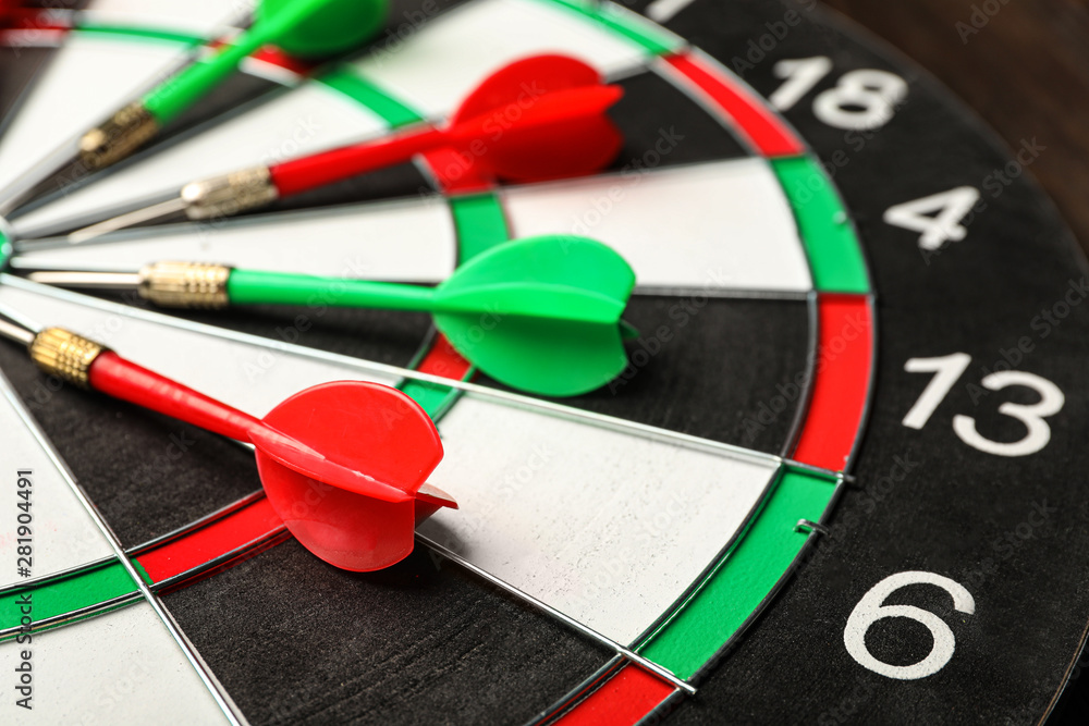 Red and green arrows on dart board, closeup Red and green arrows on dart board, closeup