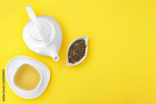 Composition with tea on yellow background, flat lay. Space for text