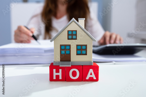 House Model Over HOA Blocks Over Desk In Office photo