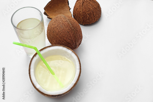Composition with coconuts and drink on white background