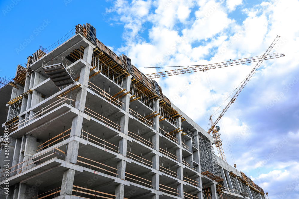 Unfinished building against blue sky. Construction safety rules