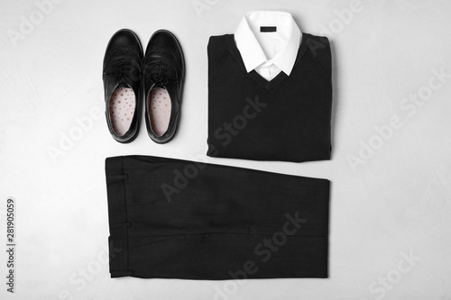 Flat lay composition with school uniform on light background