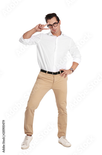 Handsome young man with glasses dancing on white background © New Africa