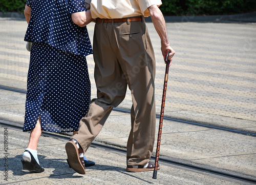 Old couple walk on the city street
