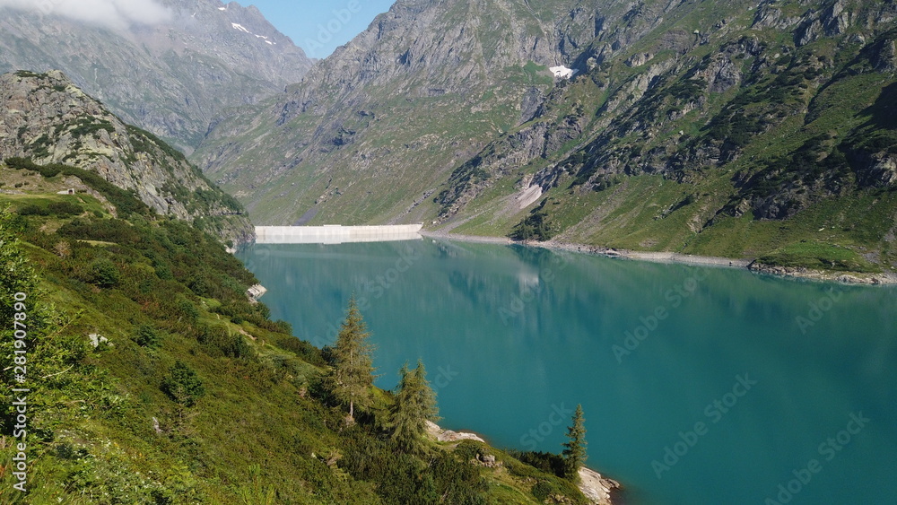 Landscape of the Lake Barbellino an alpine artificial lake. Turquoise water. Italian Alps. Italy. Orobie. Lake from which the Serio river is born. Summer time