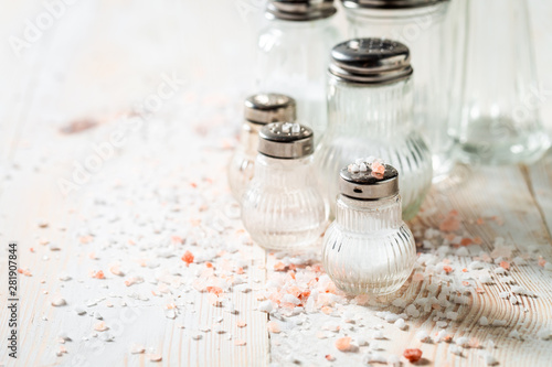 Quadro em tela White salt in salt shaker on white wooden table