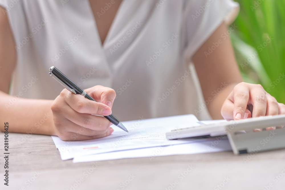 owner Sitting on the annual tax calculation Bracelets from turnover To reduce the tax. using as background business concept and finance concept with copy space for your text or design. owner Sitting on the annual tax calculation Bracelets from turnover To reduce the tax. using as background business concept and finance concept with copy space for your text or design.