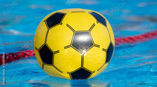 Yellow ball in the pool water