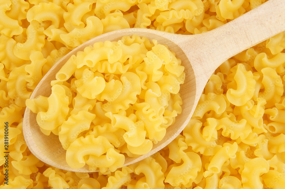 Macaroni background with wooden spoon