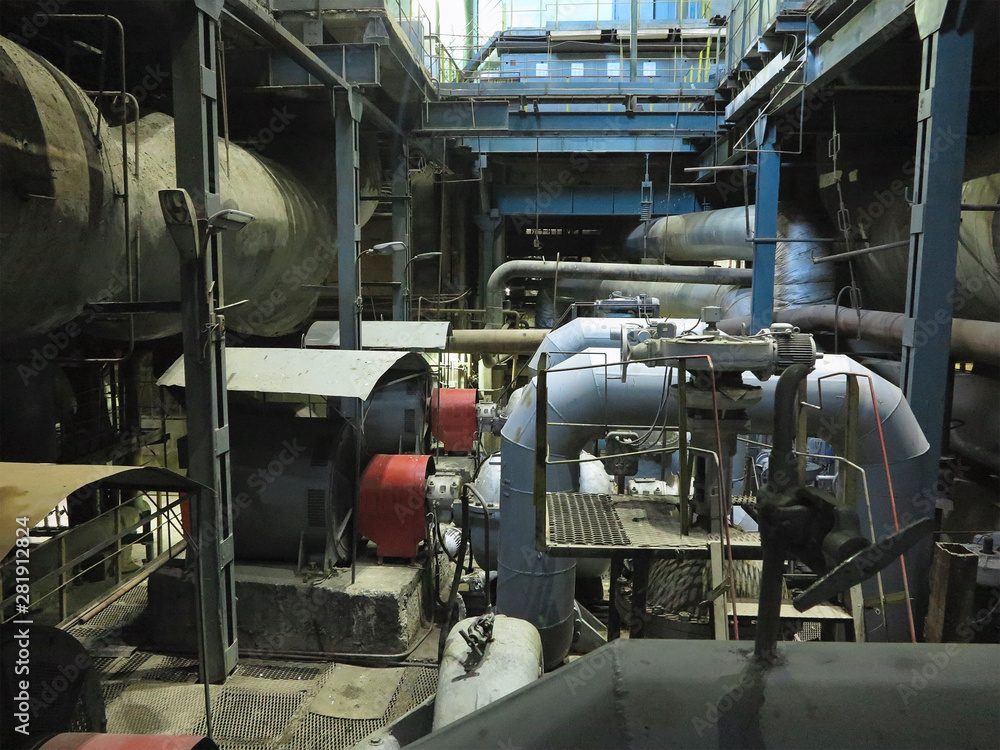 Industrial big water pumps with electric motors, pipes, tubes, equipment and steam turbine at power plant