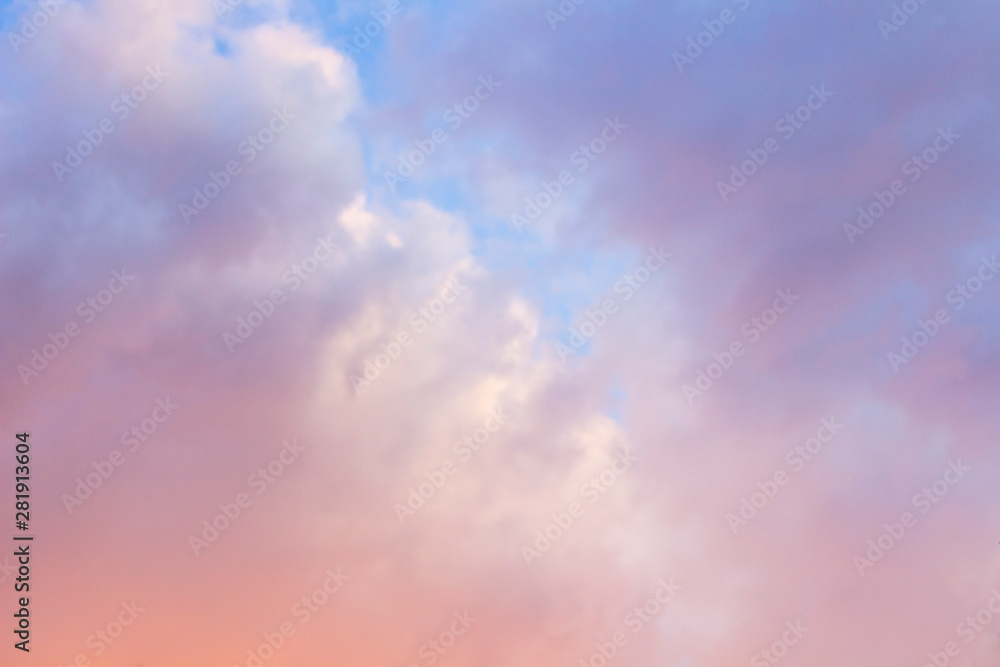 Pink clouds in the blue sky at sunset
