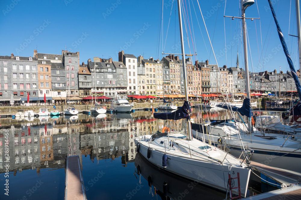 HONFLEUR, FRANCE - July 29, 2019: sailboats and pleasure boats are anchored in the port of Honfleur, France