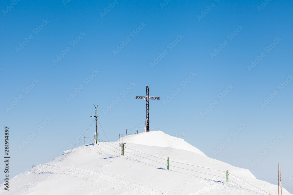 Untersberg Summit. The view across the summit of Untersberg mountain in Austria looking towards a cross. The mountain straddles the border between Germany and Austria.