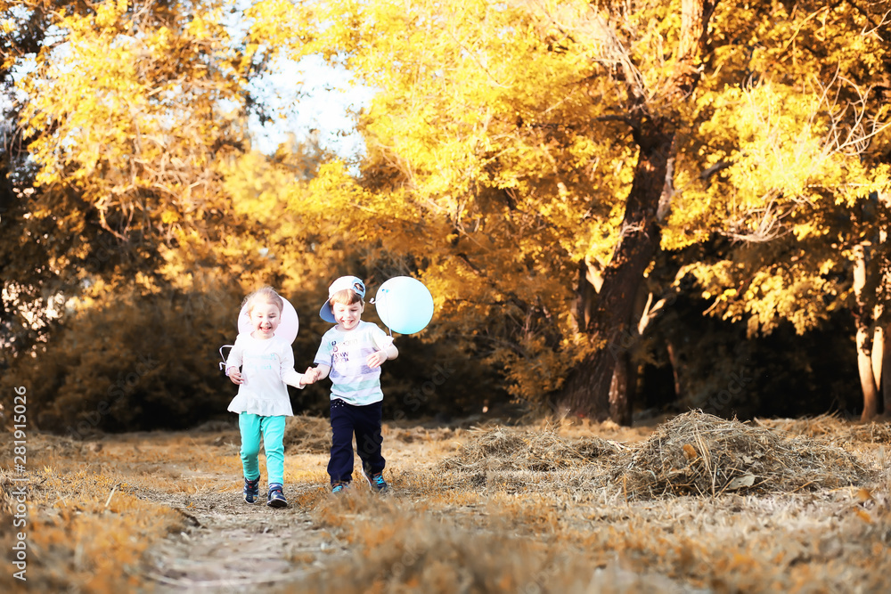 Fototapeta premium Little children are walking in autumn park