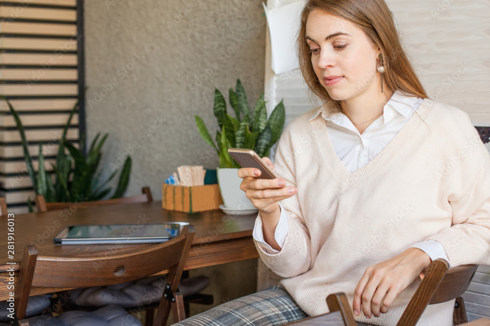 Business woman with smartphone working in open office place Business woman with smartphone working in open office place