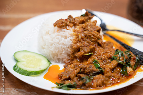 Fried lamb with curry paste on the cooked rice